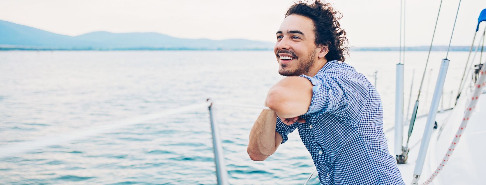 A Patelco member enjoys the view from his sailboat.