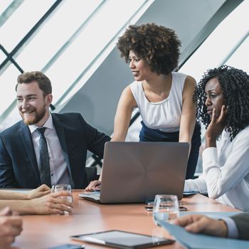 Patelco Home Loan Consultants seated around a conference table.