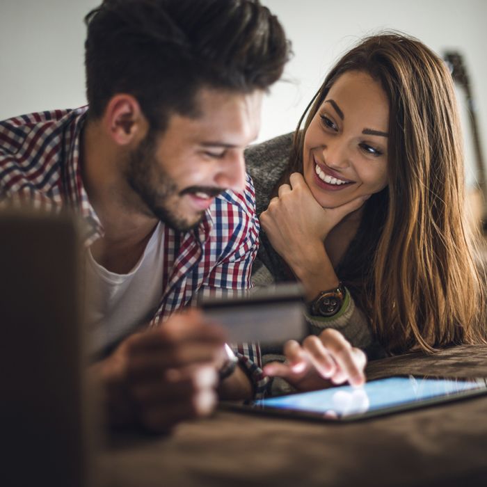 A couple manages their Patelco credit card on a tablet.