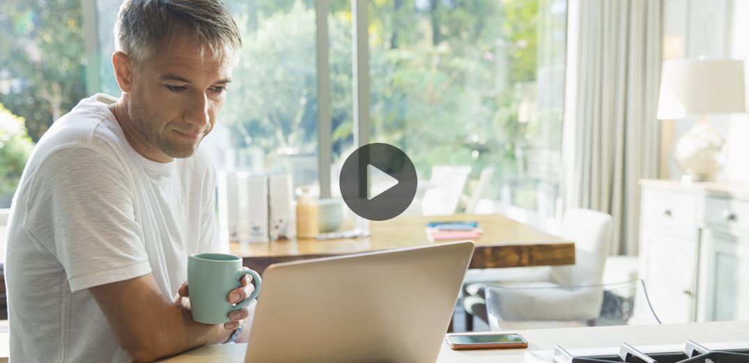 A man watches a video of Patelco members explaining why they love the credit union.