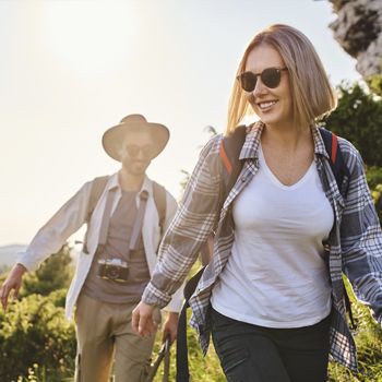 A young couple takes an afternoon hike.