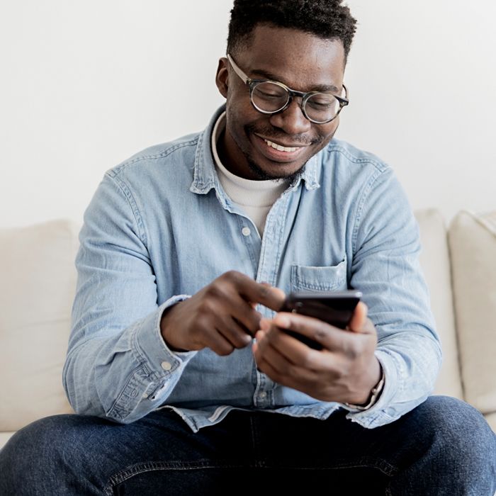 A man uses the Patelco Mobile App from his smartphone.