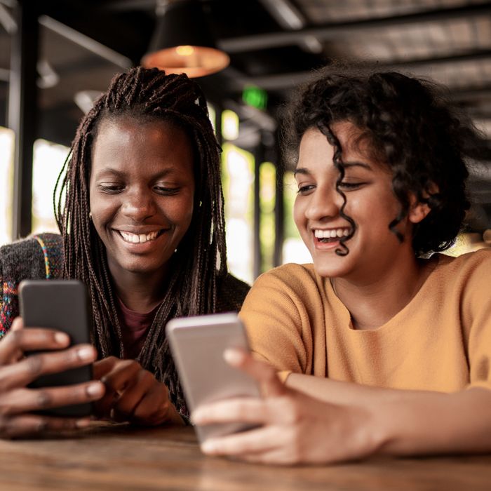 A young woman sends money to her friend using Zelle on the Patelco Mobile App.