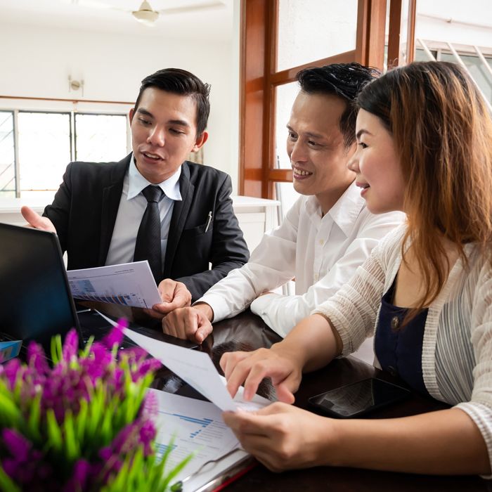 A young couple enjoying a lively discussion with their advisor about their future