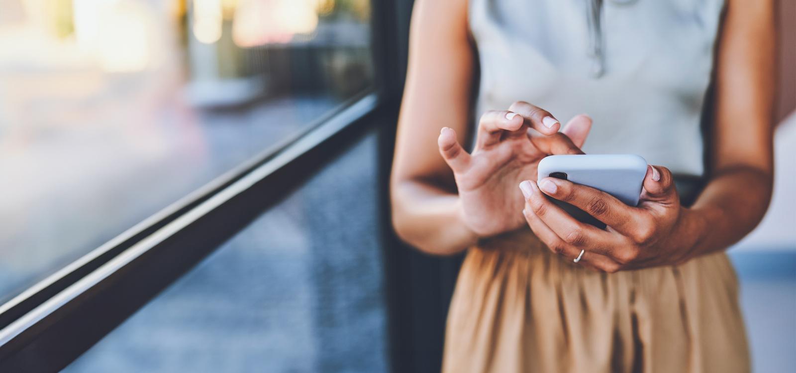 Person using mobile phone indoors